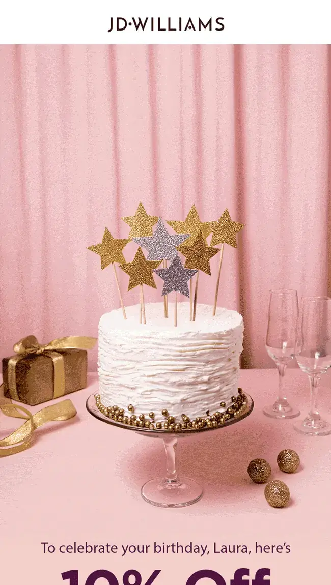 Personalised, animated JD Williams birthday hero: a white birthday cake with a gold glitter topper reading Happy Birthday Laura